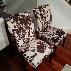 Set of 2 cowhide print dining chairs $190 obo