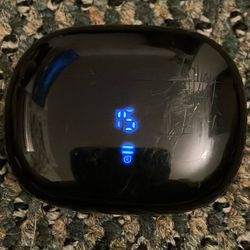 Wireless TOZO T12 bluetooth headphones with headphone dock.