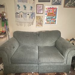 green  loveseat/ sofa 