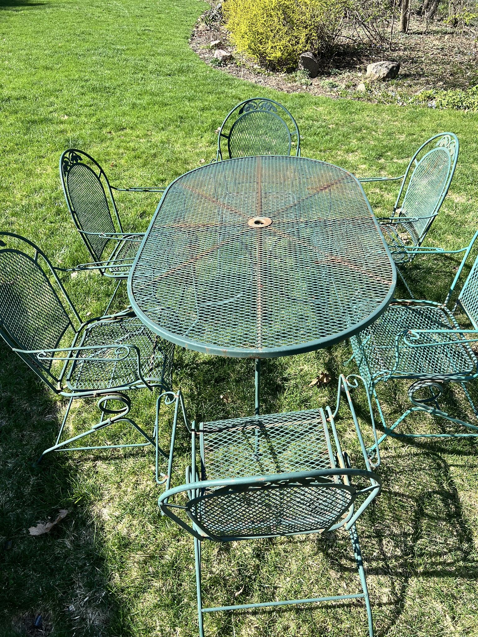 Seven piece vintage patio furniture with big table and six spring rocker chairs wrought iron