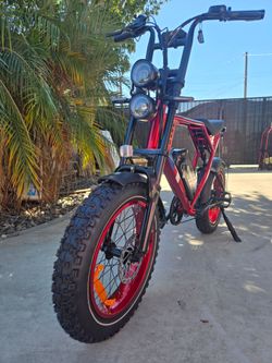 Metallic red fat tire e-bike, 34 mph adult