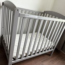 Gray Mini Crib.  Only Used A Few Times At Grandparent Home.  Couple Of Dings On Last Photos 