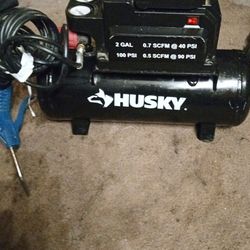 Husky. 100 psi. 2 gallon electric air compressor with air hose and blower nozzle attach in excellent condition like new