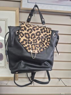Dune London black leather backpack with a genuine calf hair leopard print flap