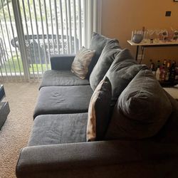 Gray Ashley Furniture Couch (with 2 pillows)
