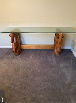 Glass table with horse head stands