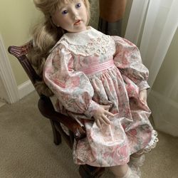 Ceramic  Doll  On Wooden Chair