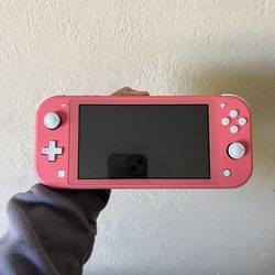 Nintendo Switch Lite in Coral with Case and Games