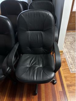 Like new black leather office chairs adjustable on wheels