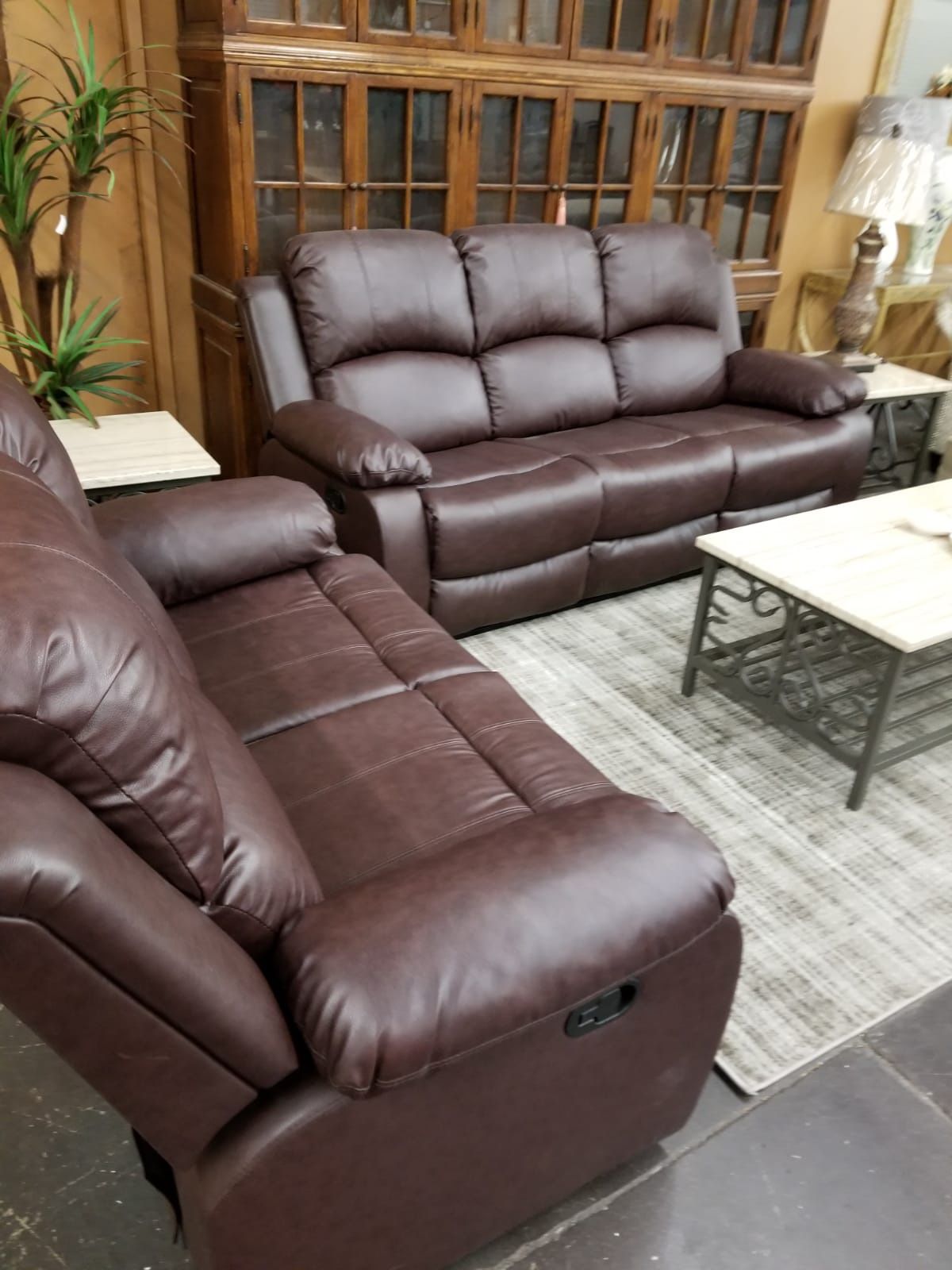 Brown leather reclining sofa and loveseat
