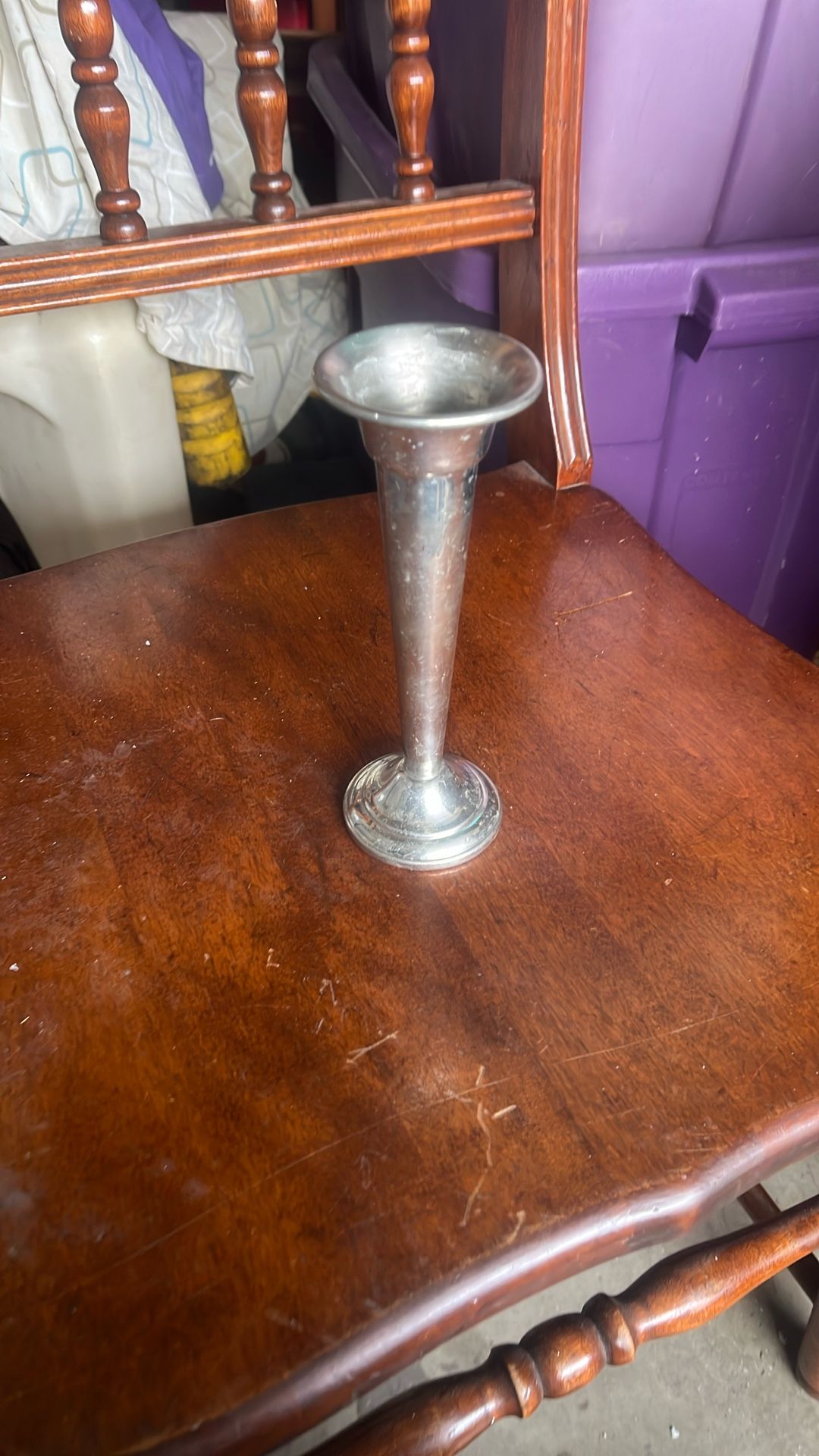 This is a silver trumpet vase. These vases are often used as decorative centerpieces for events like weddings or parties, and they are also popular as