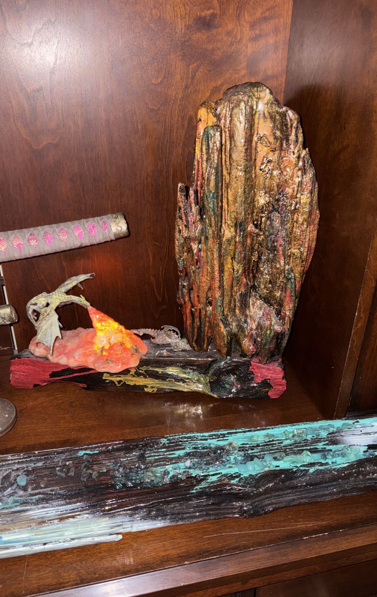 Driftwood with going in a dark epoxy, resin with a dragon that you light up that lights up at night for kids or any adult that loves dragons