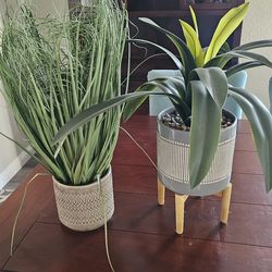 2 artificial plants with decorative pots and one wood stand