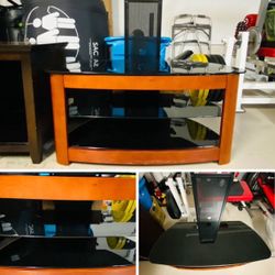 TV Stand with Black glass, metal and medium wood tone. 