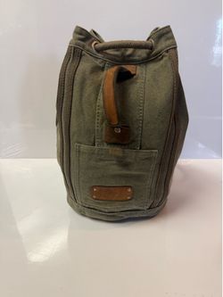 Gootium canvas backpack in army green features a distinctive drawstring closure and leather accent detailing