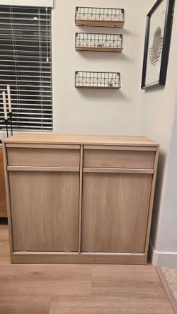 Tilt out trash can cabinet