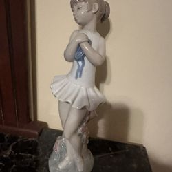 This porcelain ballerina figurine is a Nao by Lladró piece, often titled "Illusion de Ballerina" or "Ballet Girl". 11.5"