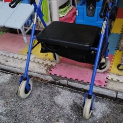 Seated Walker With Brakes  Measures 22 In Wide In Seat Area And From Back Rest To End Of Handle Bar Is  18 In Out 