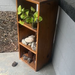 Outdoor wood shelf on a covered patio for plants