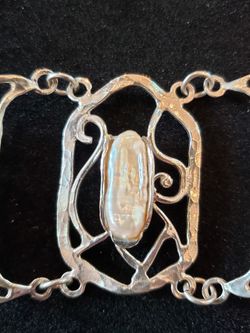 $59. Sterling vintage abstract handmade pearl bracelet. Marked 925. Three pearls. 7 in long. 1.5 in wide.