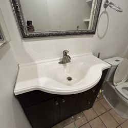 Vanity With Faucet And Mirror