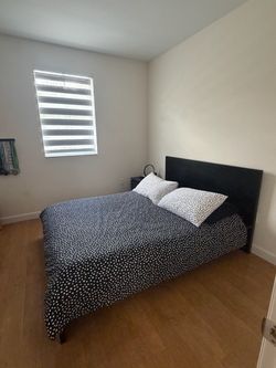 Queen Bed Frame with Black Headboard, Mattress and night table.