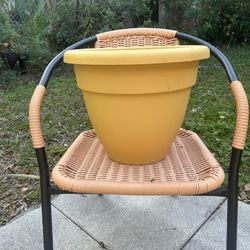 Large round yellow plastic planter pot with drainage