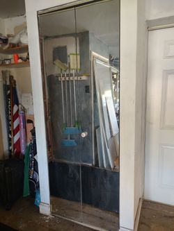 Bifold glass doors 28 in width by 78 in height, comes with the top track and the bottom track