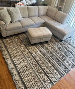 Small gray sectional with rug