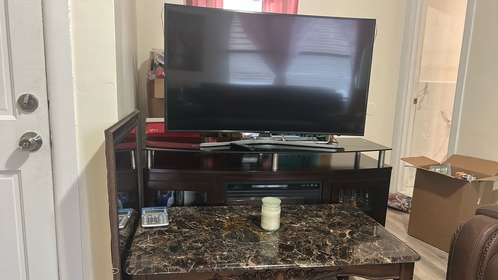 Fireplace With A 55 Curse Samsung Tv, Also Including A Coffee Table And A Round Table Dining Room With 4 Chairs . Everything On Pic