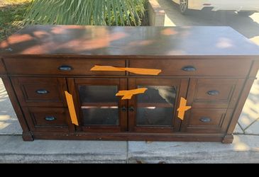 Wood TV stand with drawer and shelf/glass storage.