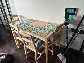 Wood dining table and 4 chairs with cushions and place mats
