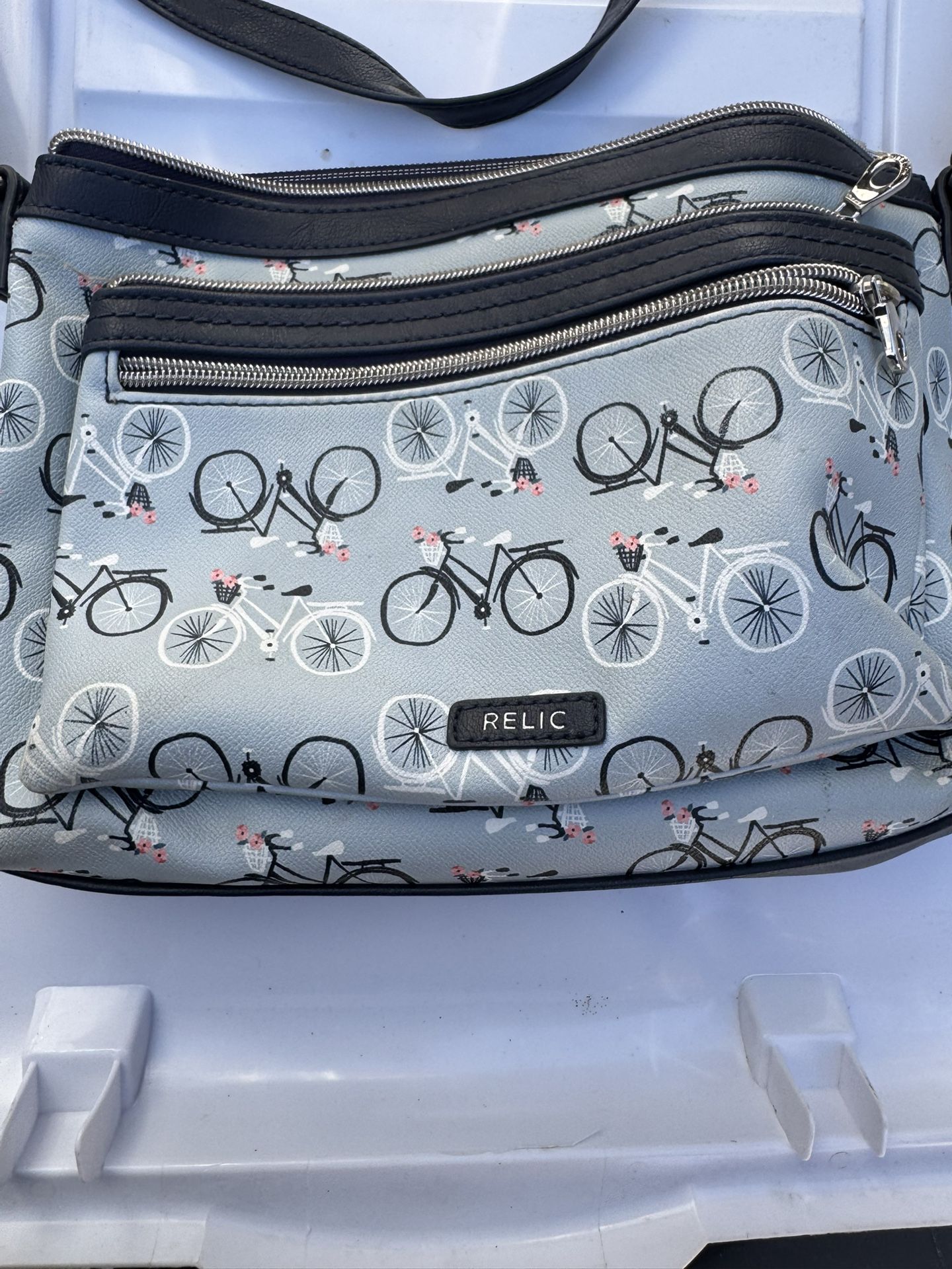 Relic crossbody bag with a bicycle print.