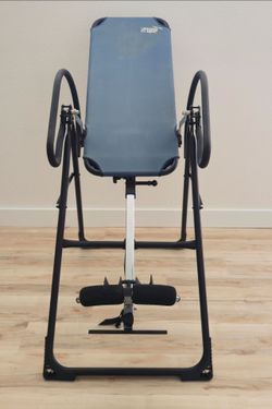 Teeter Hang Ups F5000 inversion table featuring a blue backrest and black metal frame