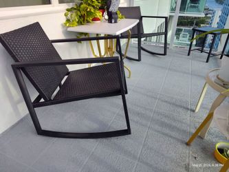 Two identical rocking patio chairs