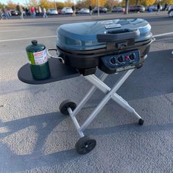 Coleman RoadTrip 285 Portable Stand 2 Burner Propane Grill BBQ Like New! Includes a custom cover and 1 propane tank. Retails $324.99