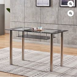 Modern tempered glass desk with a clear glass top, black lower shelf, and chrome metal legs. Stylish and sturdy design, perfect for home office, study