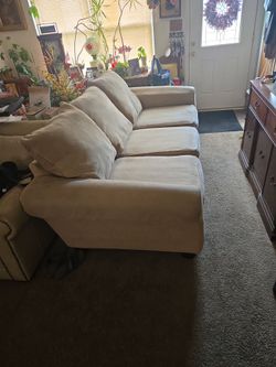Large soft tan fabric couch & Tan Leather Love seat $200.00 for the both of them.