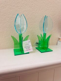 Ashland bunny and bloom tabletop decorations from Michaels feature vibrant green stems and bright blue petals.