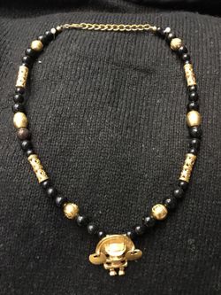 Black and gold necklace with oriental type pendant