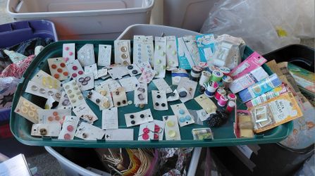 A lot of new vintage buttons, thread, belt and buckle kits, bias tape, rick rack, shoulder straps, hose supporters et cetera, from 1960's To 1970's