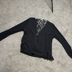 Black cardigan. Size medium. Lays down the middle of the back with gold button.