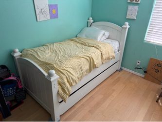 Wooden white twin trundle bed frame and mattress