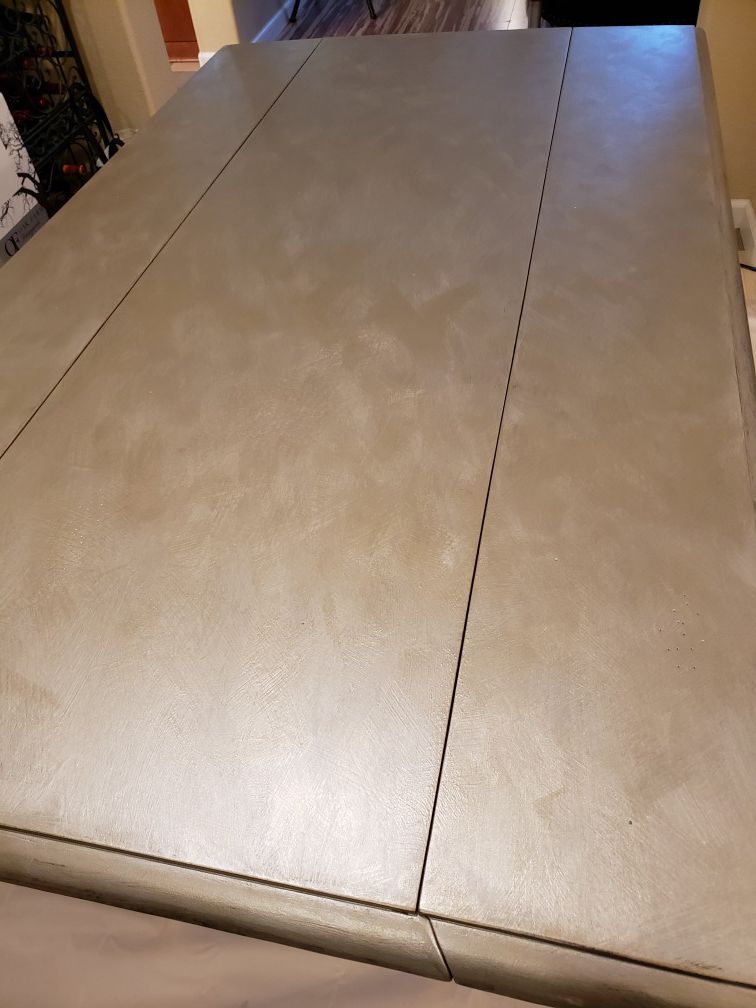Double Drop down table in Metalic Silver and Gold to look like metal. The Table looks GOLD in picture but not in person. Base is Vintage white
