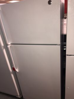 Used GE top and bottom fridge. 1 year warranty