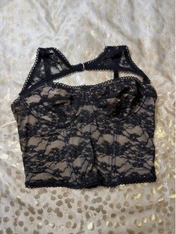 Black lace corset top with adjustable straps and bow detail. Size: S