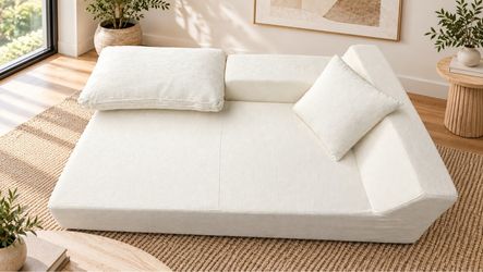 Beautiful modern chaise lounge/daybed in a soft cream/off-white color. Features a spacious, comfortable design with textured fabric, a side/back armre