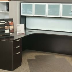 L-shaped desk with drawers and a hutch