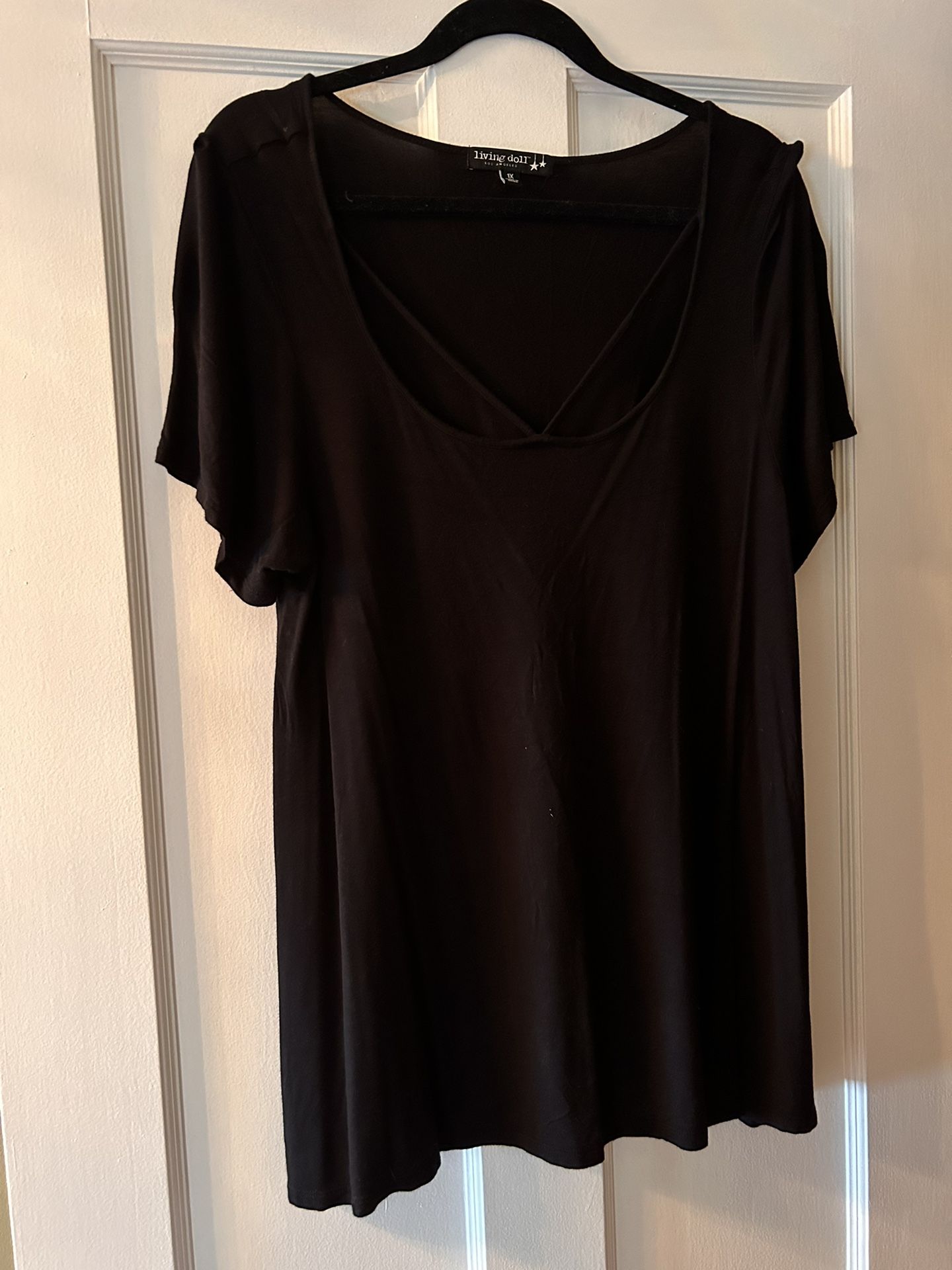 Black lightweight top with cut out at the neck. mid length or slightly longer. 