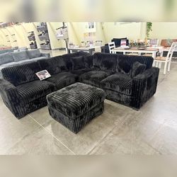 Black Jumbo corduroy sectional sofa with ottoman